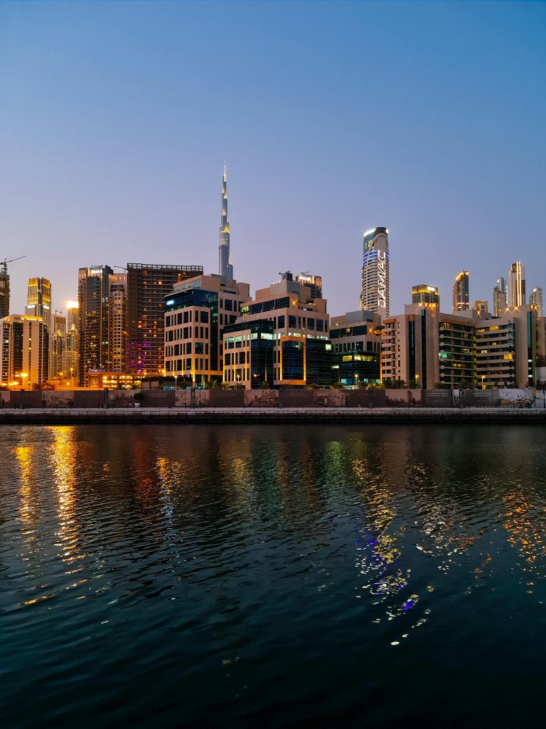 A captivating view of Dubai's skyline featuring the iconic Burj Khalifa set against a twilight sky reflecting on the water.