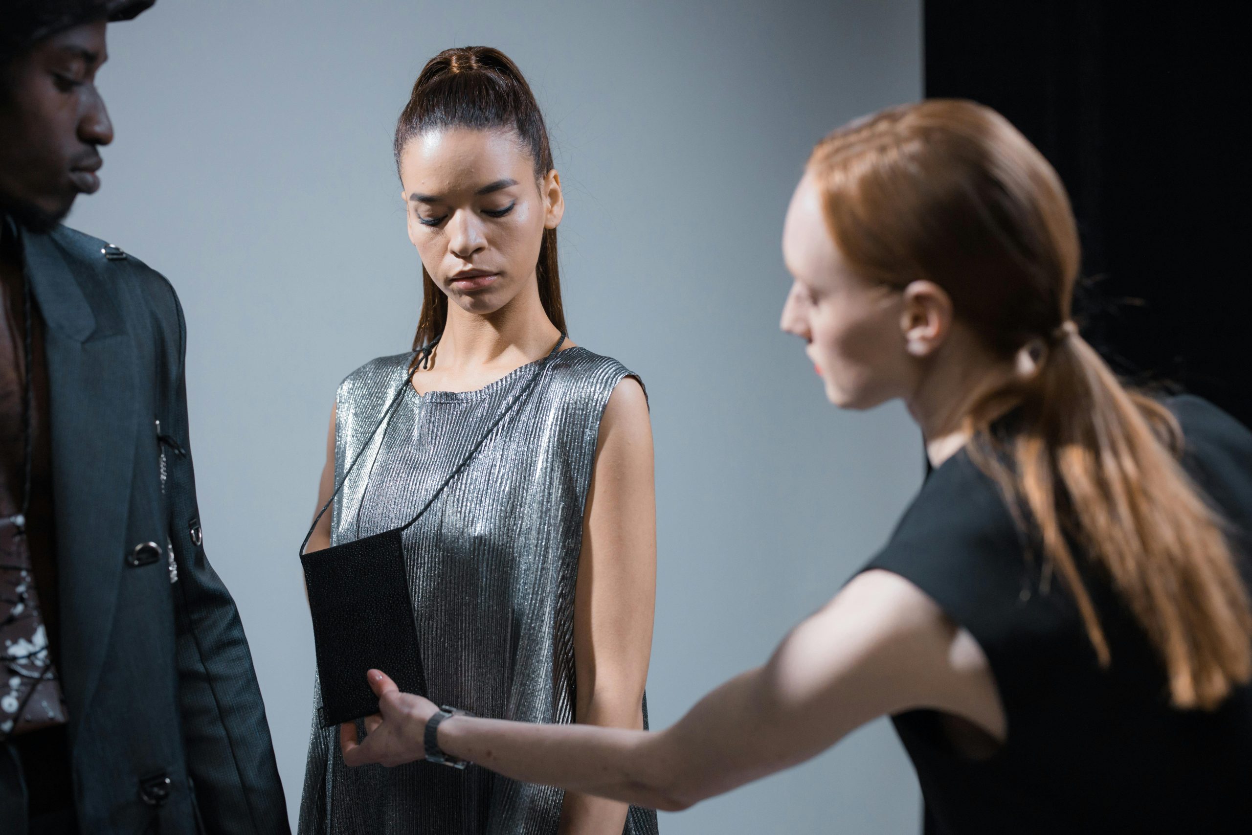 Models preparing in a studio for a fashion shoot, showcasing diverse styles and designs.